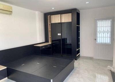 modern bedroom with built-in storage and large wardrobe
