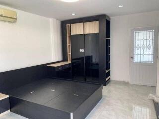 modern bedroom with built-in storage and large wardrobe