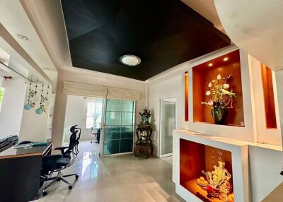 Modern and stylish living area with black ceiling and decorative display