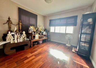Decorated room with wooden floors and statues