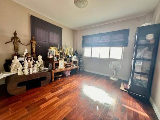 Decorated room with wooden floors and statues