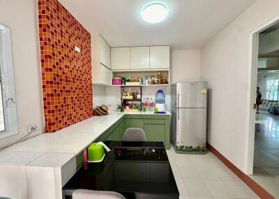 Modern kitchen with colorful tile backsplash and dining area