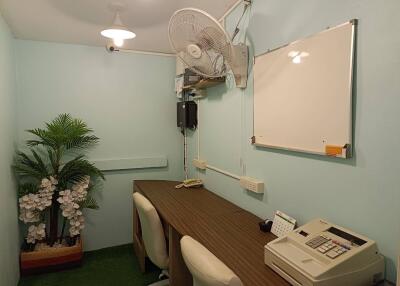 Small office with desk, chairs, and office equipment
