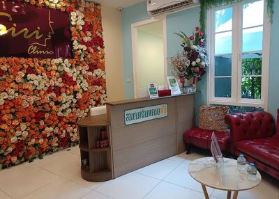 Reception area of a property with floral backdrop and furniture