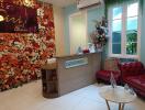 Reception area of a property with floral backdrop and furniture