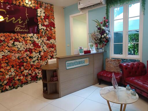 Reception area of a property with floral backdrop and furniture