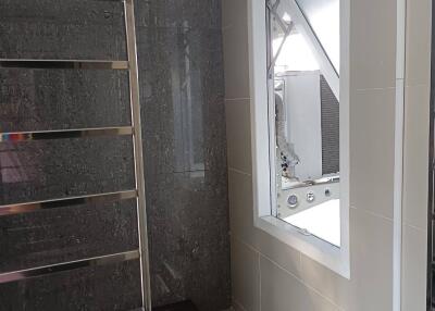 Modern bathroom with towel rack and large window