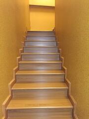 staircase with wooden steps and yellow walls