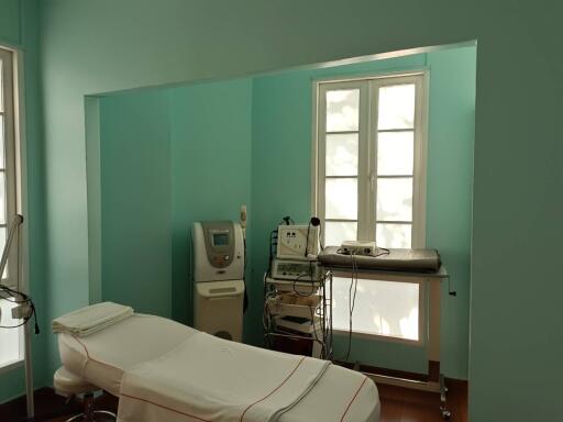 Medical room with treatment bed and medical equipment