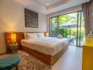 cozy bedroom with large glass doors leading to a lush backyard