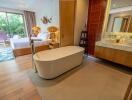 Spacious bedroom with ensuite bathroom featuring a modern bathtub