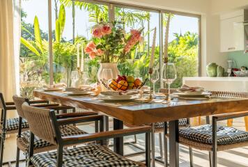 Well-lit dining area with a wooden table, modern chairs, and table setup