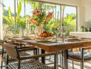 Well-lit dining area with a wooden table, modern chairs, and table setup