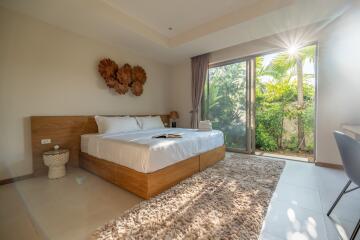 Spacious bedroom with large window and natural light