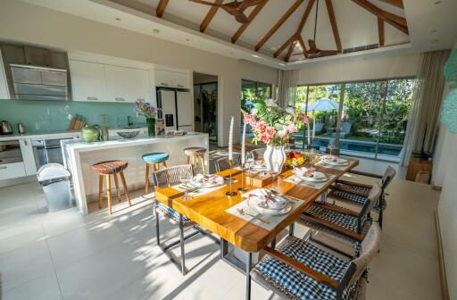 Modern kitchen and dining area with large windows and pool view