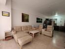 Spacious living room with beige seating and artwork on the walls