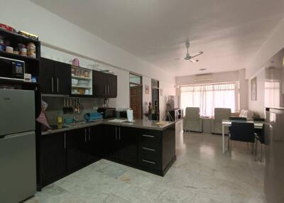 Spacious kitchen with modern appliances and adjoining living/dining area