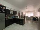 Spacious kitchen with modern appliances and adjoining living/dining area