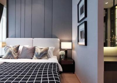 Contemporary bedroom with stylish decor, featuring a large bed, pillows, nightstands, artwork, and ambient lighting.