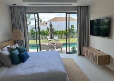 Bedroom overlooking pool with patio access