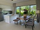 Modern kitchen with dining area and large windows