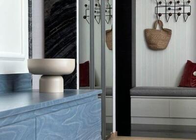 Modern interior with a seating nook and sleek blue cabinetry