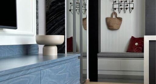 Modern interior with a seating nook and sleek blue cabinetry