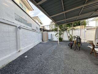 Covered outdoor area with bicycles and gravel floor