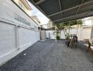 Covered outdoor area with bicycles and gravel floor