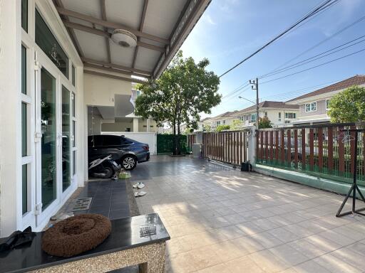 Outdoor area with a parked car and shaded seating