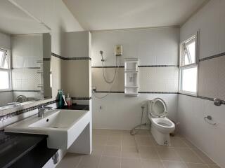 Modern bathroom with sink, shower, and toilet