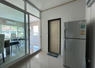 Modern kitchen with refrigerator and dining area view