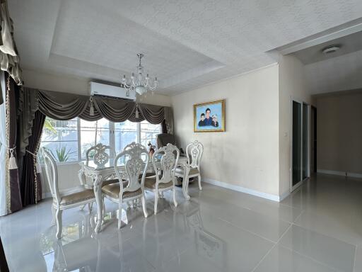 Elegant dining room with chandelier and large windows