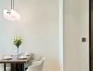 Modern dining area with table set and decorative lighting