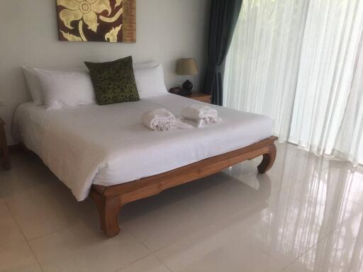 Bedroom with a large bed and natural light