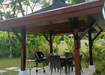 Covered outdoor dining area with pool