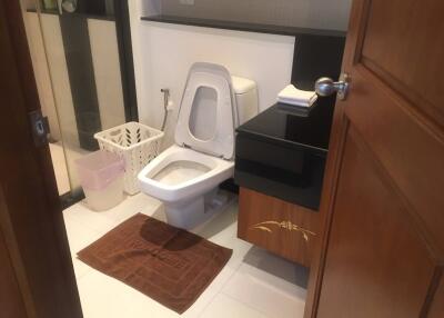 Modern bathroom with toilet, sink, and shower