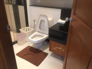 Modern bathroom with toilet, sink, and shower