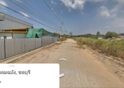 Rural street view with industrial building and open land