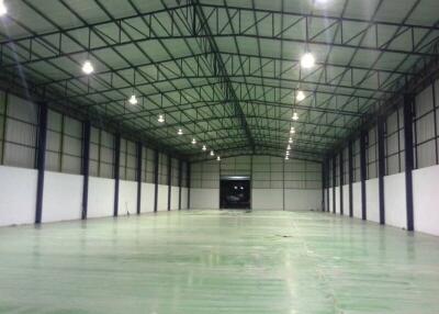 Interior of a spacious warehouse with high ceilings and bright lighting