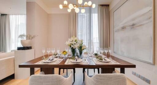 Modern dining room with a well-set table and contemporary chandelier