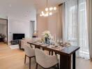 A modern living and dining area with a well-set dining table and a cozy sitting area in the background.