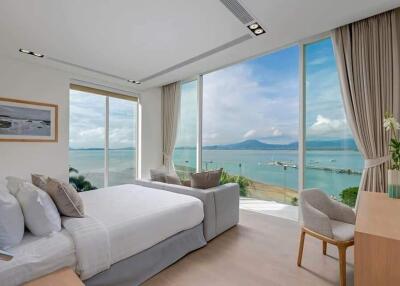 Luxurious bedroom with a panoramic ocean view and modern interior