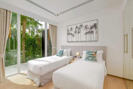 Modern bedroom with twin beds, large window, and outdoor view