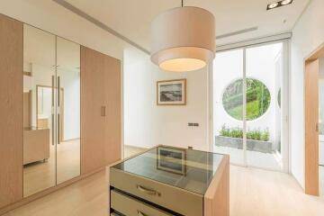 Spacious bedroom with mirrored wardrobes and large windows