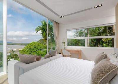 Modern bedroom with large windows offering a scenic outdoor view