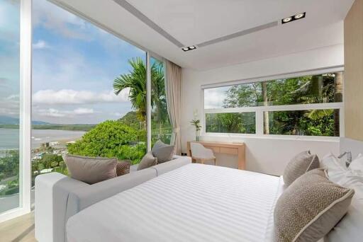 Modern bedroom with large windows offering a scenic outdoor view