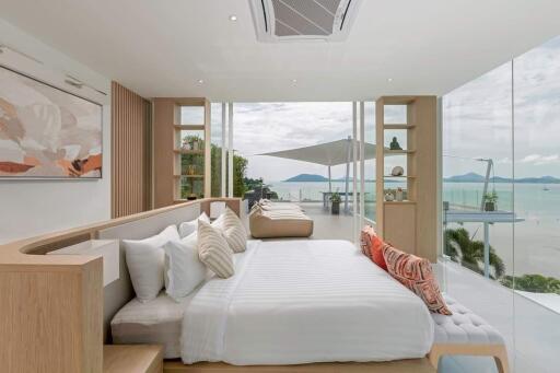 Modern bedroom with large windows offering ocean view