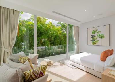 Bright modern bedroom with large windows and garden view