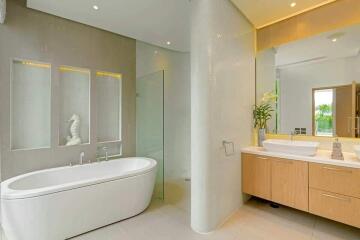 Modern bathroom with bathtub, glass shower, and double sink vanity